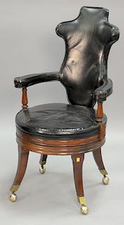 Continental style leather swivel office chair on mahogany base.
