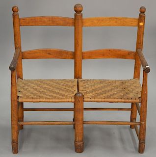 Primitive ladderback double settee with woven rush seat. wd. 33 in.