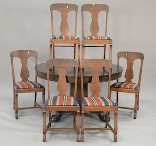 Seven piece set with round oak table with two 10 1/2" leaves and six oak chairs