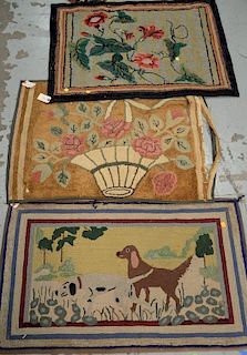 Three hooked rugs including a sporting dogs rug 2' x 3'3", one with basket of flowers 2'3" x 3' (some damage), and one floral 2'4" x...