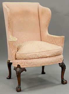 Mahogany Chippendale style upholstered wing chair with bird's heads on legs and ball and claw feet, early 20th century.