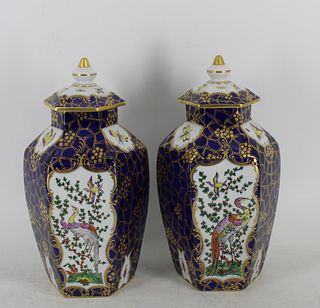 A Pair Of Dresden Porcelain Lidded Urns.