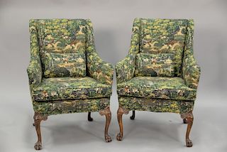 Pair of upholstered chairs with claw feet, upholstery with sporting scenes.