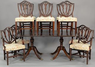 Eleven piece dining set including ten shield back custom mahogany dining chairs and double pedestal table with leaves. ht. 30 1/2 in...