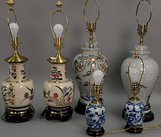 Three pairs of table lamps including pair of blue and white small table lamps, a pair of crackle glaze table lamps and one other pai...