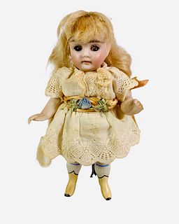 All Bisque socket head girl. 5" doll with mohair wig, glass sleep eyes, open mouth with teeth, on five-piece body with molded and painted yellow boots