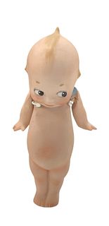 Little bisque Kewpie w/blue wings, strung arms, small linear fault on neck in bisque. Approx 5 1/2" tall.