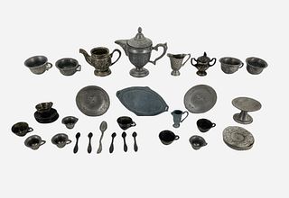 Lot of miniature dollhouse kitchen and dining items made of pewter type metal. Includes platters, cups, silverware, pitchers, plates and bowls. Talles