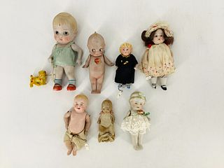 Lot of 7 vintage bisque dolls, smallest is 4" tall. Includes a Kewpie w/partial sticker, doll in lace and green ribbon marked Ã¬Nippon", a 6 1/2" tall