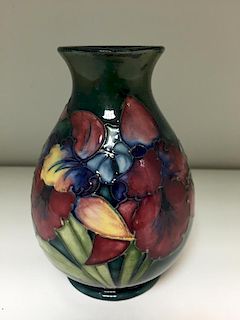 A Moorcroft Orchid pattern vase, the baluster form decorated to a green ground, impressed marks and
