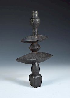 A cast iron candlestick, cast after a design by Diego Giacometti, signed to base 33½cm (13in) <br>Di
