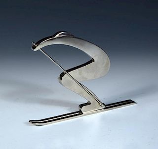 A silvered bronze model of a stylised skier after the original by Hagenauer, modelled in a crouched
