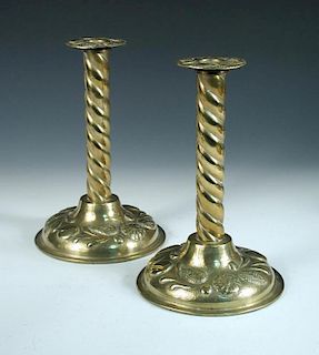 A pair of Arts & Crafts brass candlesticks, each with twist columns, the scones and spreading circul