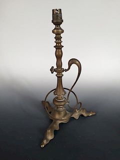 An Art Nouveau brass table lamp, the turned column supported on three shaped feet with scrolling han