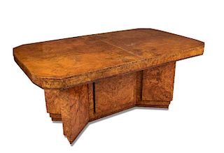 A good Art Deco walnut extending dining table, the rectangular top with canted corners raised on a d