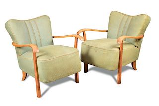 A pair of Art Deco open armchairs, the shaped backs and over stuffed seats in pale green fabric upho