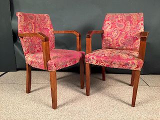 A pair of Art Deco walnut open arm chairs, each with angular arms and fabric upholstered backs and s