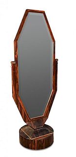 An Art Deco coromandel wood cheval mirror in the manner of Emile Jacques Ruhlmann, the shaped bevell