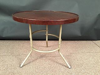A 1950s bakelite occasional table, the circular top raised on a tubular aluminium base 53 x 60cm (21