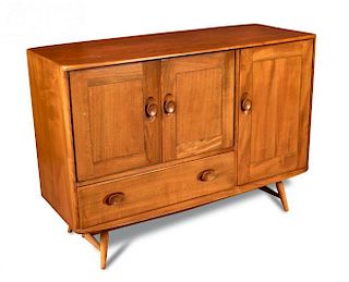 An Ercol elm sideboard, the rounded rectangular top above single right-hand cupboard with integral c