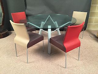 A contemporary glass topped circular dining table and eight Mike Montis chairs, the table with archi