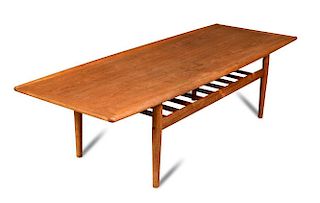 Grete Jalk for P. Jeppesen, a Danish teak coffee table, the shaped rectangular top raised on four ta