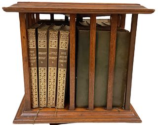 Collection of 16 leather bound Dickens novels in solid wood spinner case.