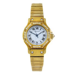 CARTIER - a Santos bracelet watch. Yellow metal case with diamond set bezel, stamped 18k with poinco