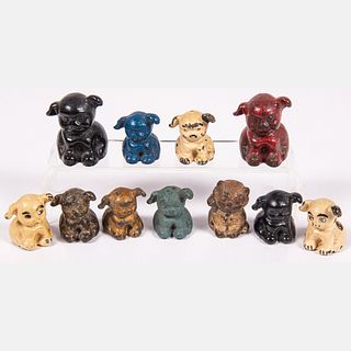 Ten Cast Iron and Steel Advertising Puppy Paperweights