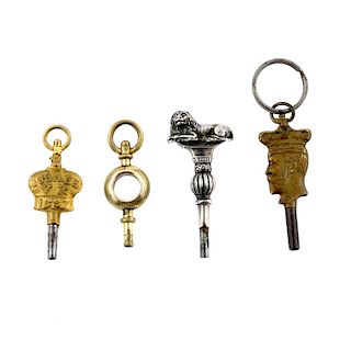 A group of four pocket watch keys, including a white metal example in the shape of a lion atop a bal