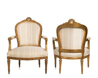 A pair of French Louis XVI-style fauteuils