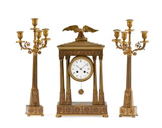 A French Empire-style gilt-bronze mantel clock and candelabra set