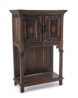An English Gothic Revival carved wood court cupboard