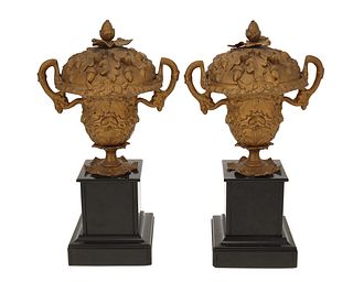 A pair of gilt-bronze lidded urns