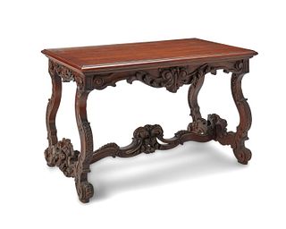 A Venetian-style carved wood trestle table