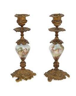 A pair of French gilt-bronze and porcelain candlesticks