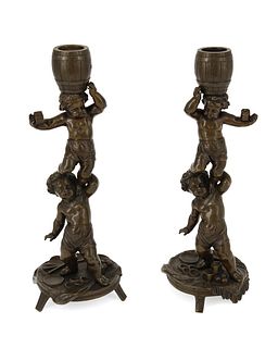 A pair of French bronze figural candlesticks
