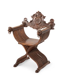 A carved wood Savonarola chair