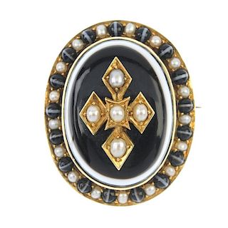 A mid Victorian gold banded agate and split pearl memorial brooch. Of oval outline, the banded agate