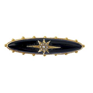 A late 19th century gold memorial brooch. Designed as a marquise-shape onyx set to the central star-