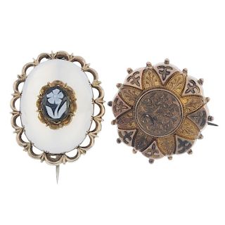 Two late Victorian brooches. The first of oval-outline with scalloped surround to the white chalcedo