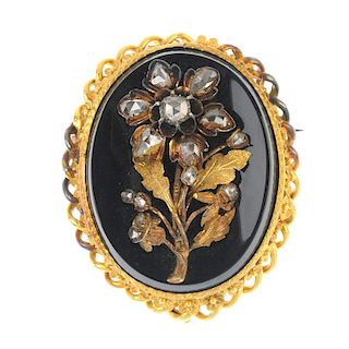 A late Victorian gold onyx and diamond brooch. Of oval outline, the onyx panel with applied flower w