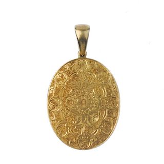 A late 19th century gold photograph pendant. The oval-shape floral and foliate engraved pendant, wit