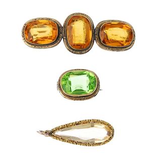 Two late 19th century paste brooches and a citrine pendant. To include a brooch, the oval-shape gree