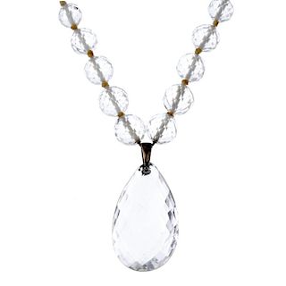 A mid 20th century rock crystal bead necklace. The pear-shape drop, to the graduated faceted beads.
