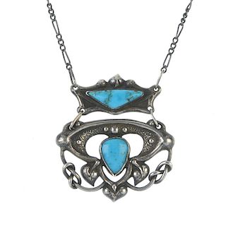 An early 20th century silver and turquoise pendant. The two panels of abstract foliate design, the t