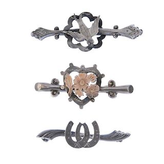 Five Edwardian and Georgian silver brooches. To include one designed as two horseshoes to the curvin