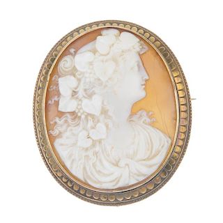 A late 19th century 18ct gold shell cameo brooch. Of oval outline, carved to depict a bacchante, wit