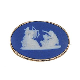 A 9ct gold cameo ring and a Wedgwood brooch. The ring designed as an oval-shape carving depicting a