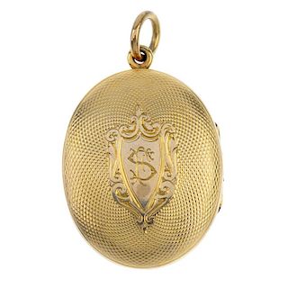 A late Victorian locket. The gold front and back locket is of oval outline with engine turned decora